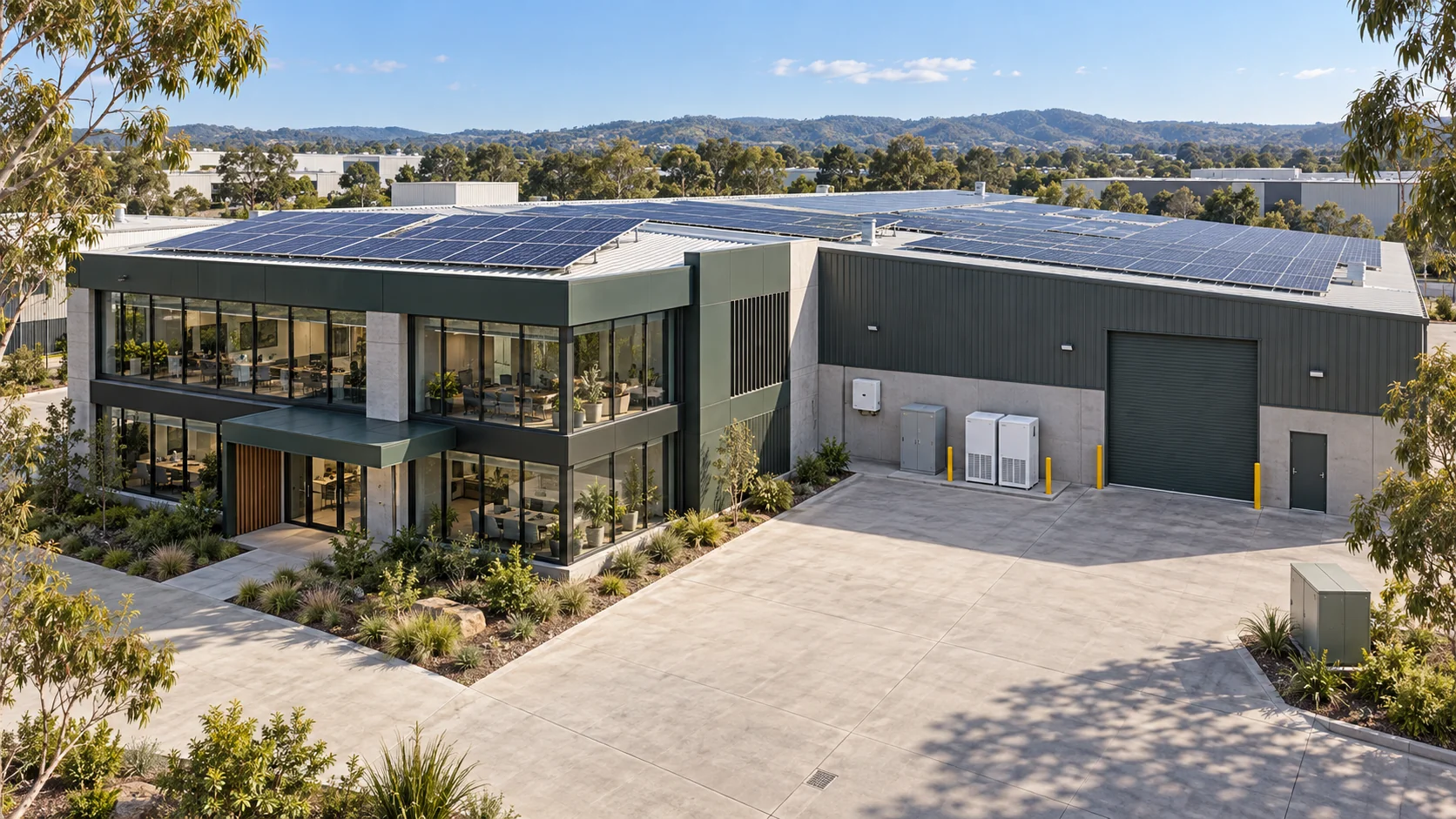 Concept of an Australian office and warehouse complex with rooftop solar, a solar inverter, AC switchboard and two commercial battery cabinets